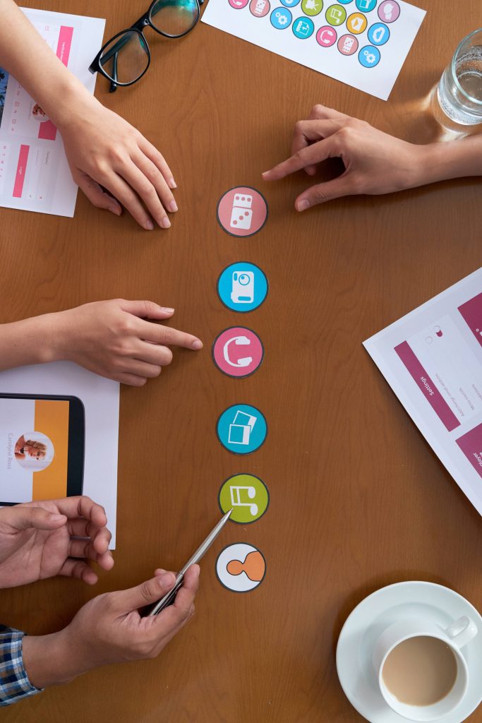 hands unrecognizable work colleagues discussing icons project